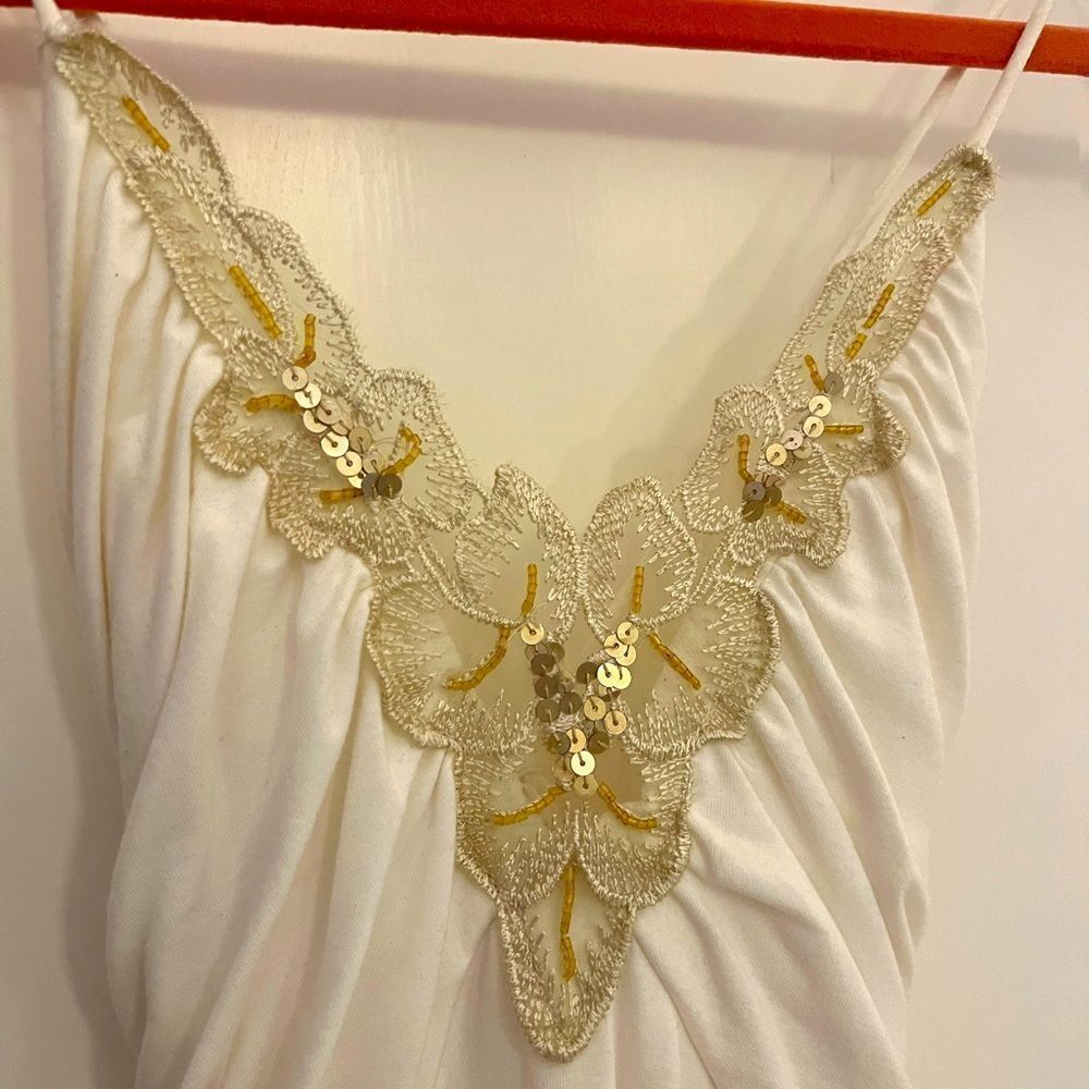 White dress with gold embellishments in medium